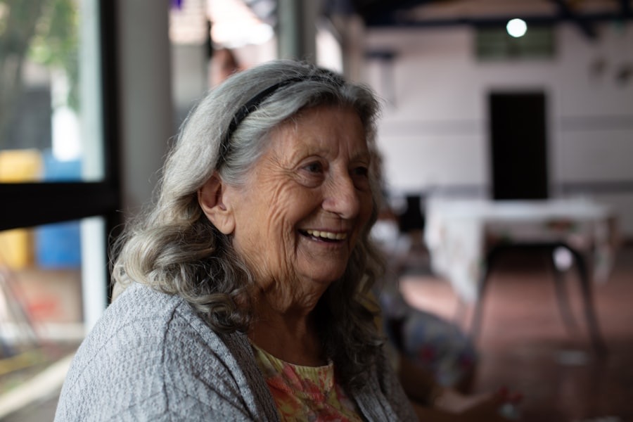 An older lady laughing in her cardigan
