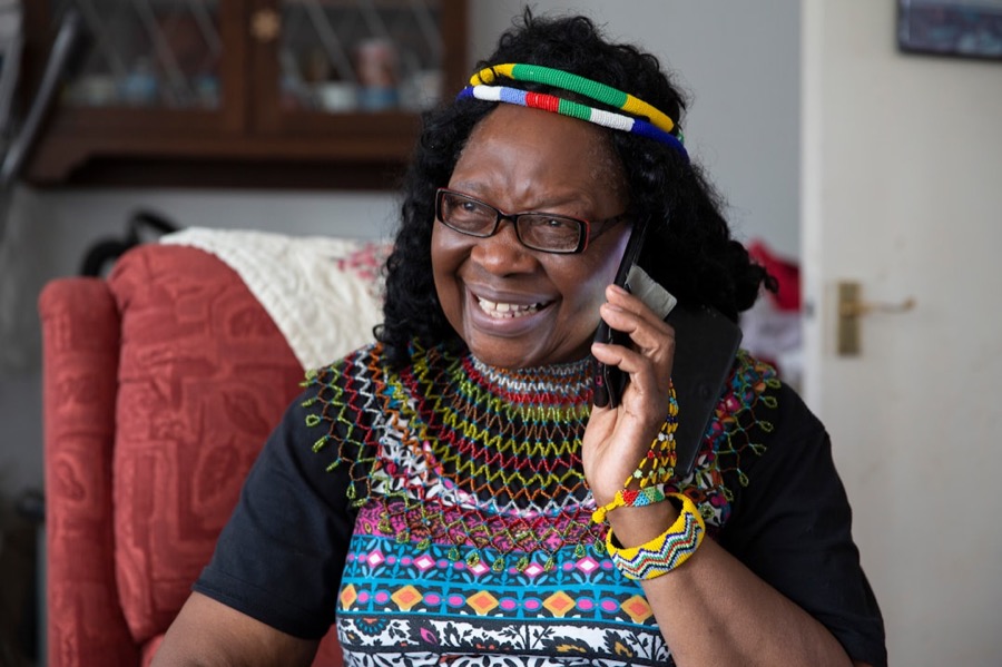 An older lady laughing on her morning check-in call